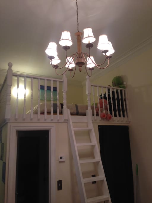 View up to loft bed. Bathroom and apartment entrace door are built in under the loft. Great use of space.