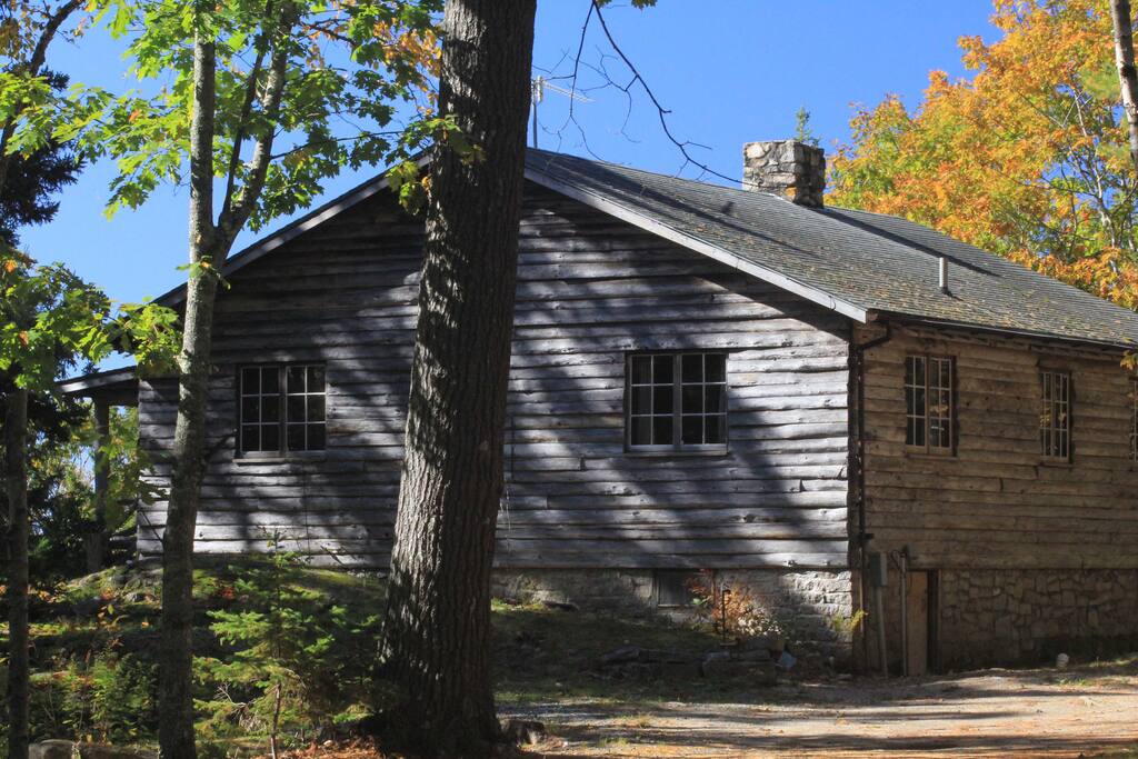 A log style cottage but with knotty pine paneling inside and modern amenities.
