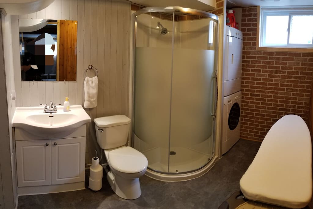 Full bathroom with washer and dryer in the basement.