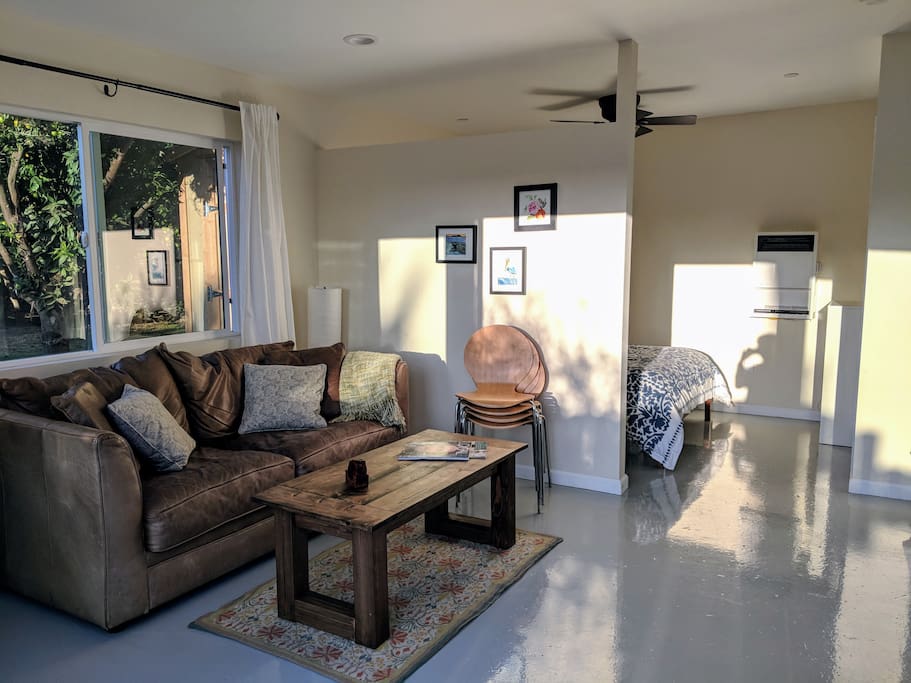Sitting area shows pullout sofa bed and connection to sleeping nook