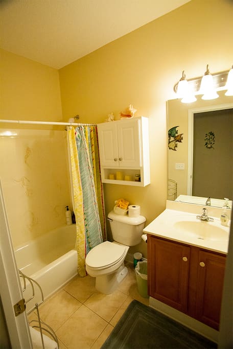 private bathroom with bath/shower and amenities