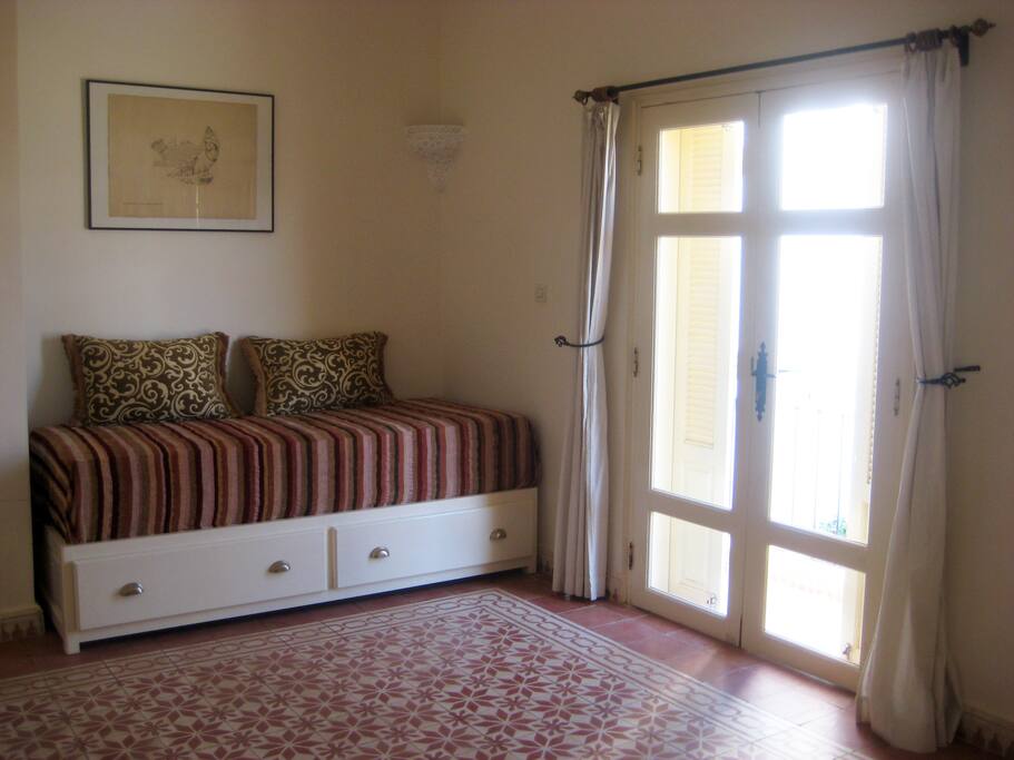 The single bed in the room (made up as a sofa when not in use)