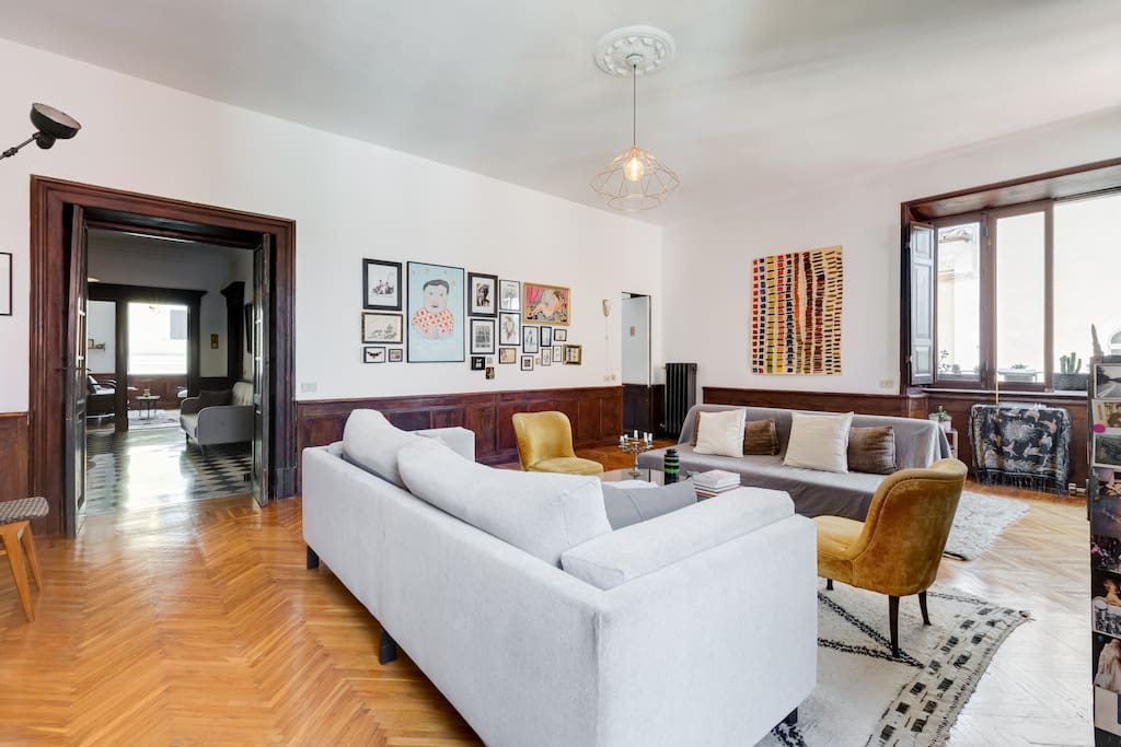 The living room is very large, with two full sofas, and has so much light.