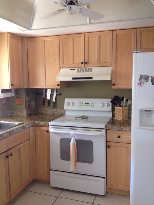 Freshly painted kitchen. Well stocked with dishes, pots, pans, utensils.