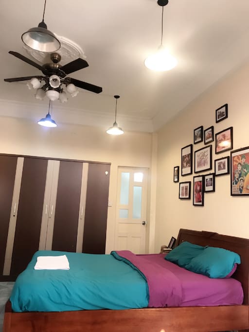 Other view of the bed with ceiling lights and a big closet.