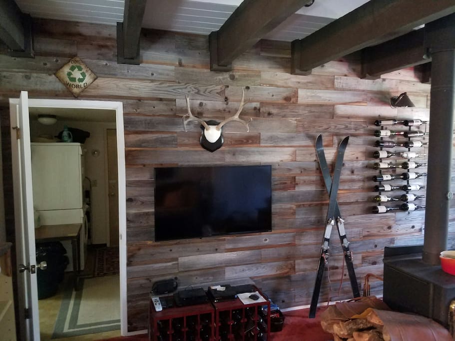 View of tv and laundry room beyond