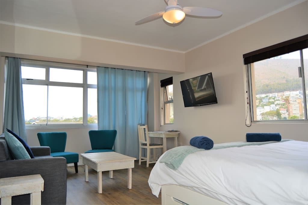Comfortable queen bed with TV on swing arm so you can watch TV from the bed or couch plus great big windows looking on to the mountain and Green Point park