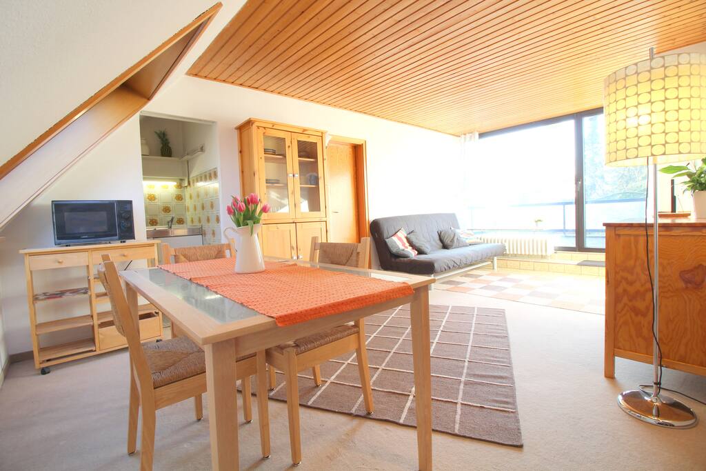 From the dining table one has a wonderful view of the roof top terrace and the bright window.