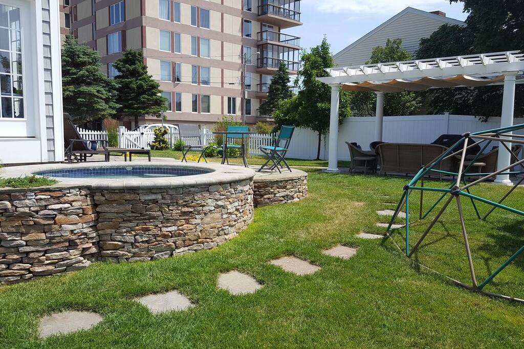 Outdoor hot tub located on the side of the patio.