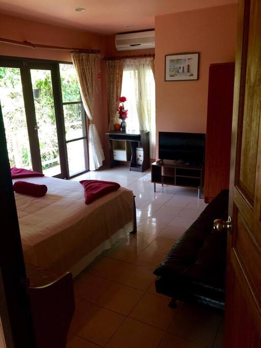 The Master bedroom, with king-size bed TV, desk, en suite bathroom and balcony