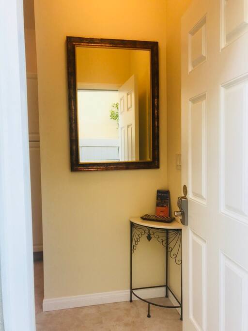 Entrance way with big mirror. (Check your hair before you go out?)