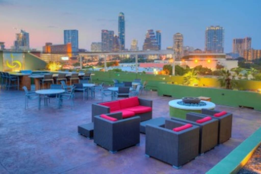 Rooftop with plasma TVs, a grill, bar counter, fire pit, and incredible skyline view of the city!