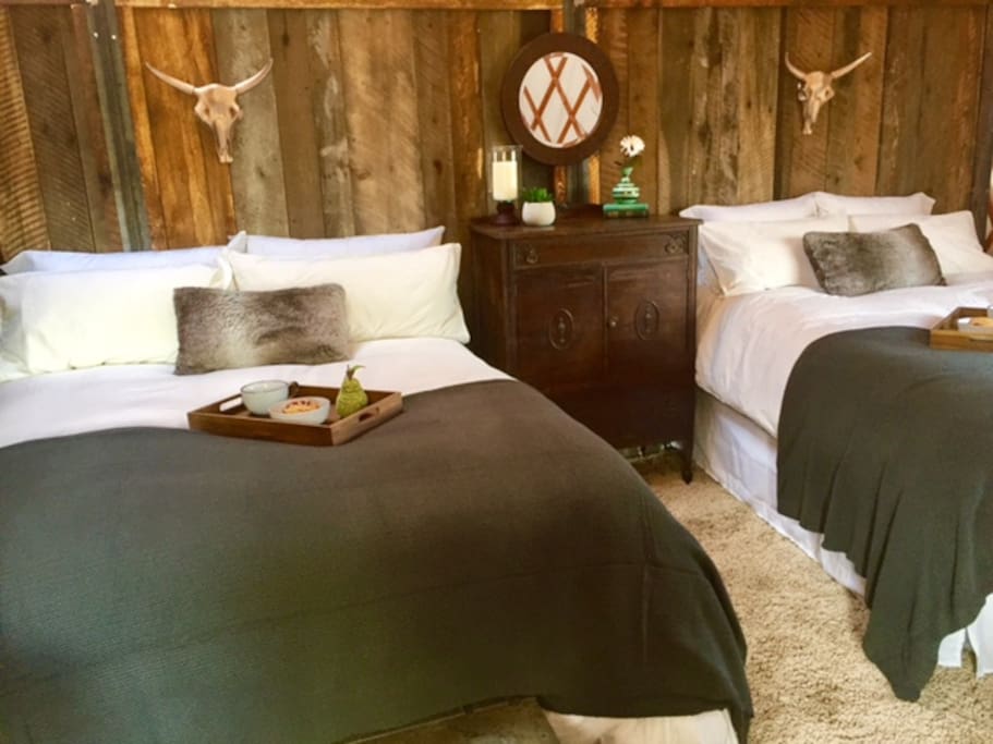 Our cozy yurt bedroom with two queen beds and sitting area