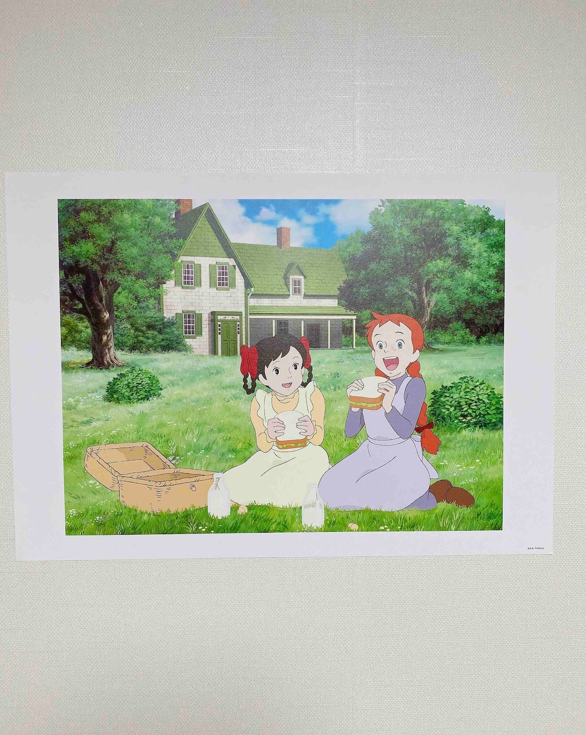 A vibrant illustration features two children seated on grassy ground, surrounded by lush greenery. They are smiling while holding food. In the background, a charming house with a green roof is visible, providing a quaint atmosphere enhanced by the trees and garden.