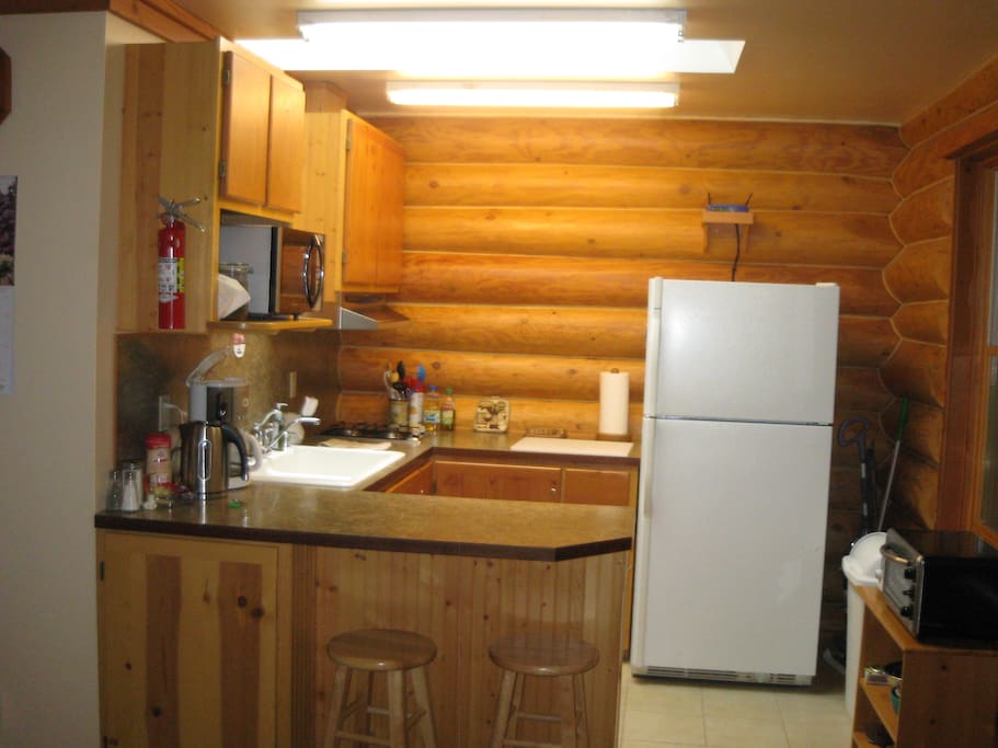 Kitchen with microwave, toaster, toaster oven, coffee and tea, skylite
