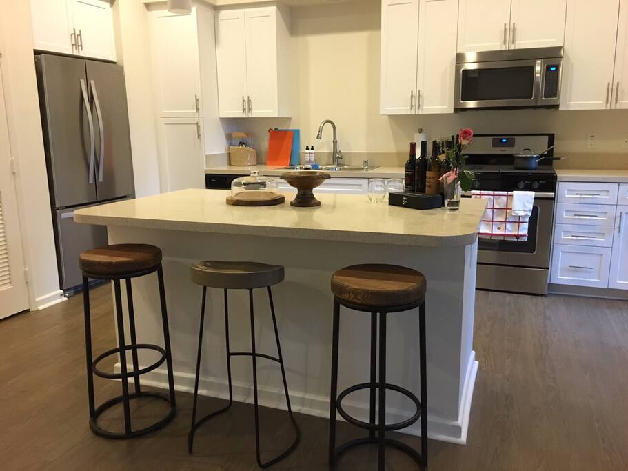 Gorgeous and spacious kitchen with stainless steel appliances, granite countertops, and a gas range!