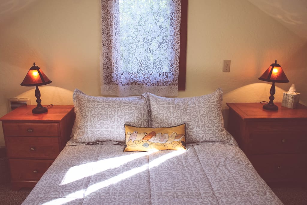 Full sized bed in a cozy loft.