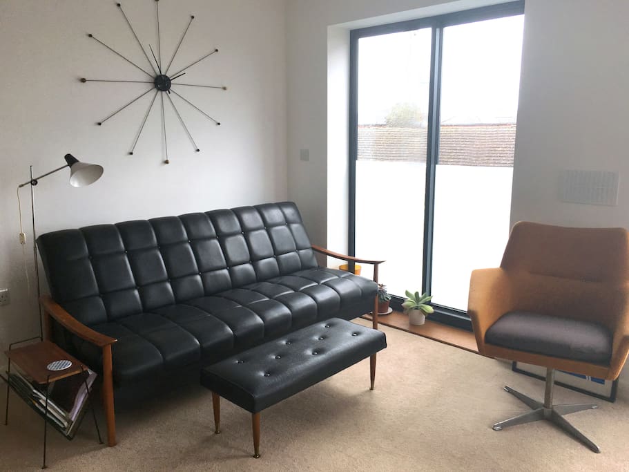 Open plan living area with floor to ceiling windows