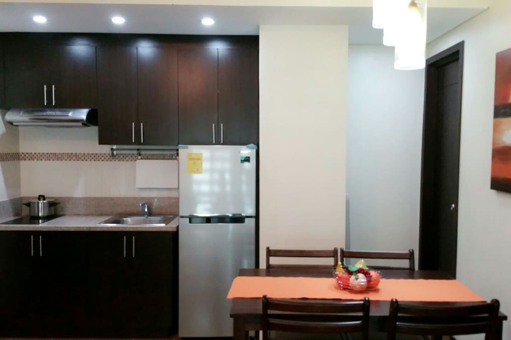 Kitchen with induction stove, electric kettle, rice cooker.