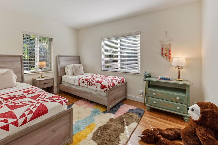 Third bedroom with two twin beds and our resident house mascot, Bowie the sloth!