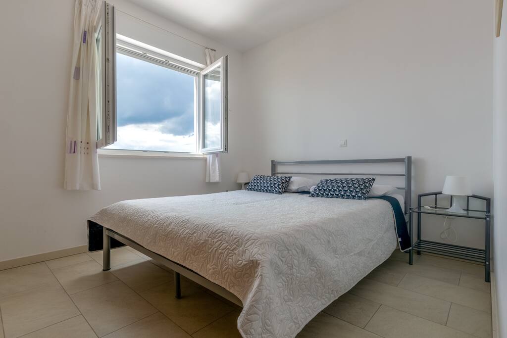 Spaceous bedroom with night stands and wardrobe, with enough space for a cot