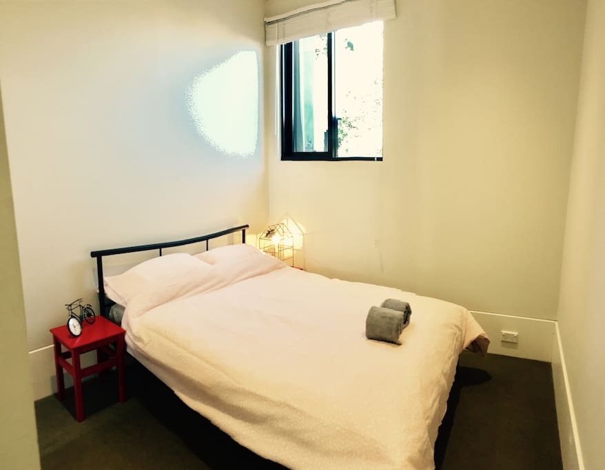 Double bed with fresh bed linen and towels. With window facing sunny garden.