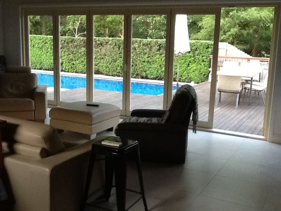Lounge overlooking bush land and pool