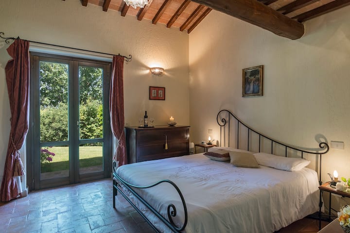 Bedroom 2 with balcony overlooking the outdoor portico