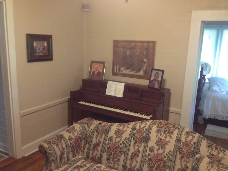 Sitting Room with Piano.
Your bedroom is entered from door on right of piano.