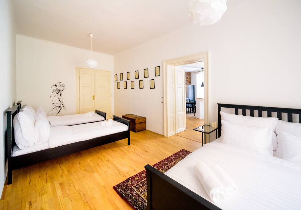 Bedroom 01 comfortably accommodates 4 guests - 1 double bed by the window and 2 single beds on the left-hand side. On the wall at the back meet the life-size creature painting guarding this room against bad spirits.