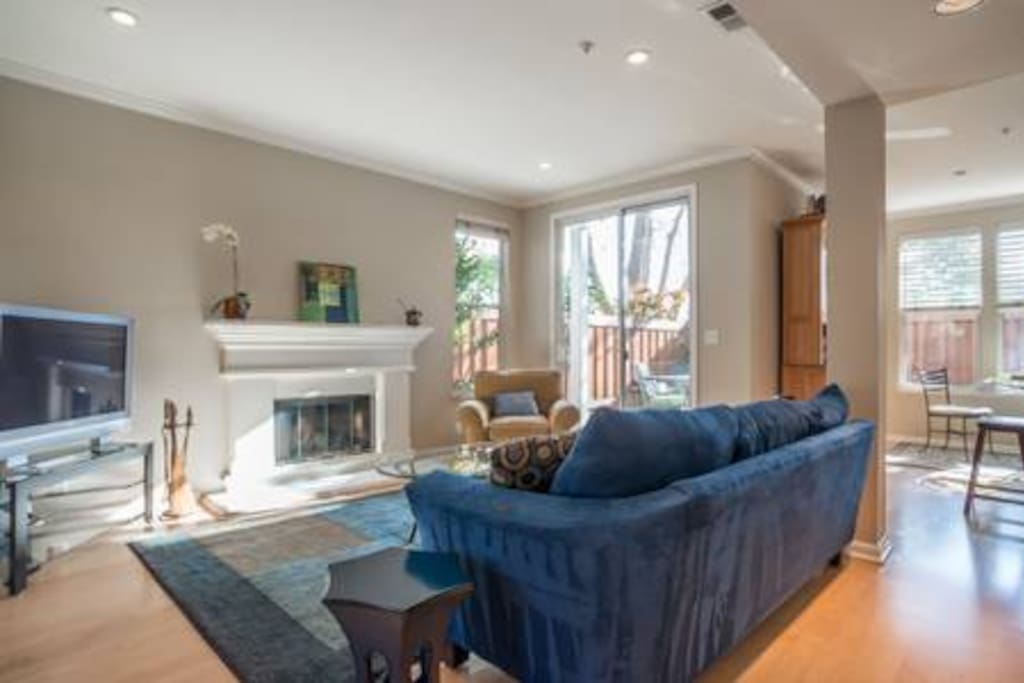 Living room with 40" smart tv, fireplace and sliding door to patio.