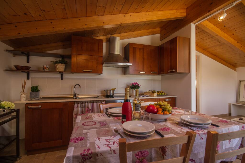 Living room with kitchen, dining area and sleeping sofa for two