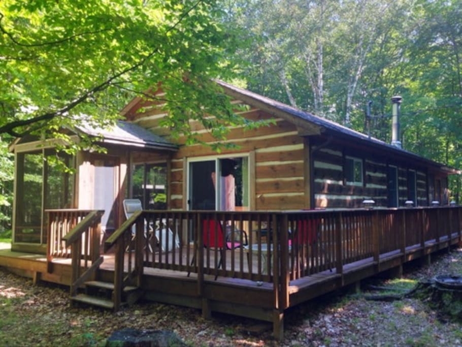 Screened in back porch off one bedroom, and access to wrap around deck from second bedroom
