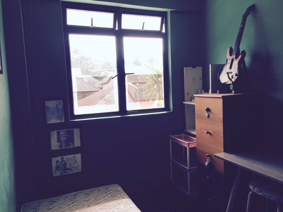 Window facing the road. Shelves and drawers to the right.