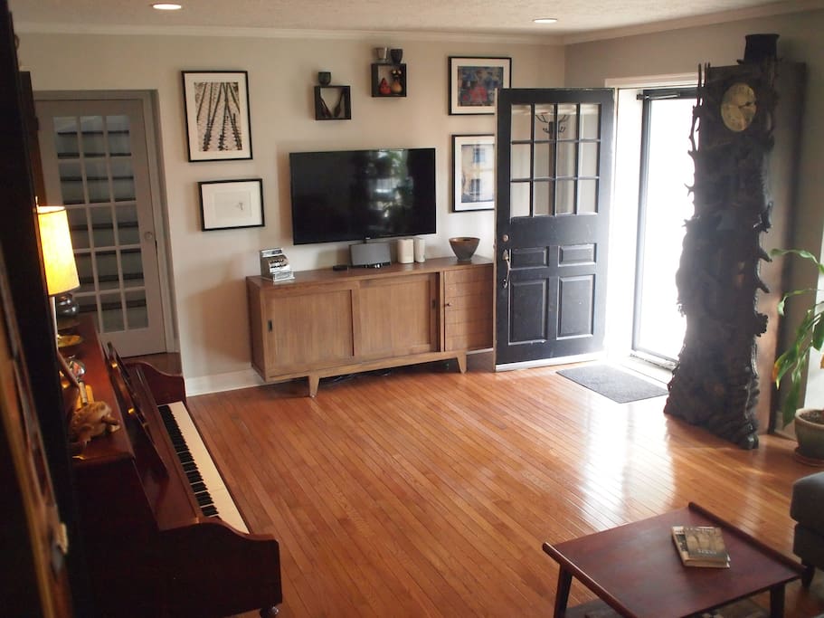 Living room equipped with streaming media smart TV & beautiful upright piano.