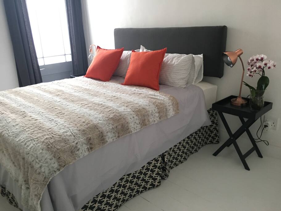 Light-filled bedroom opens out onto a private outside shower
