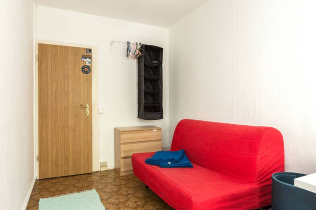 The room - bed is the flamboyant red pull-out couch