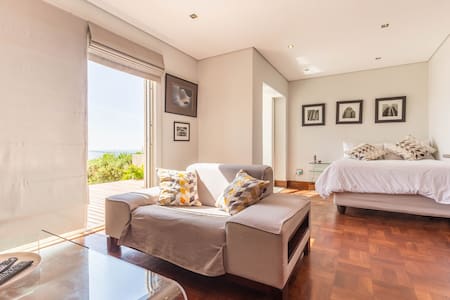 Modern studio in Camps Bay with deck and sea view.