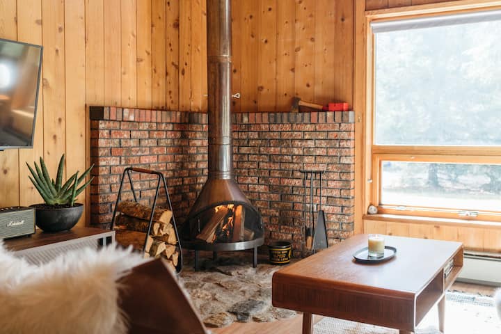 The living room with vintage Preway fireplace and flat screen TV