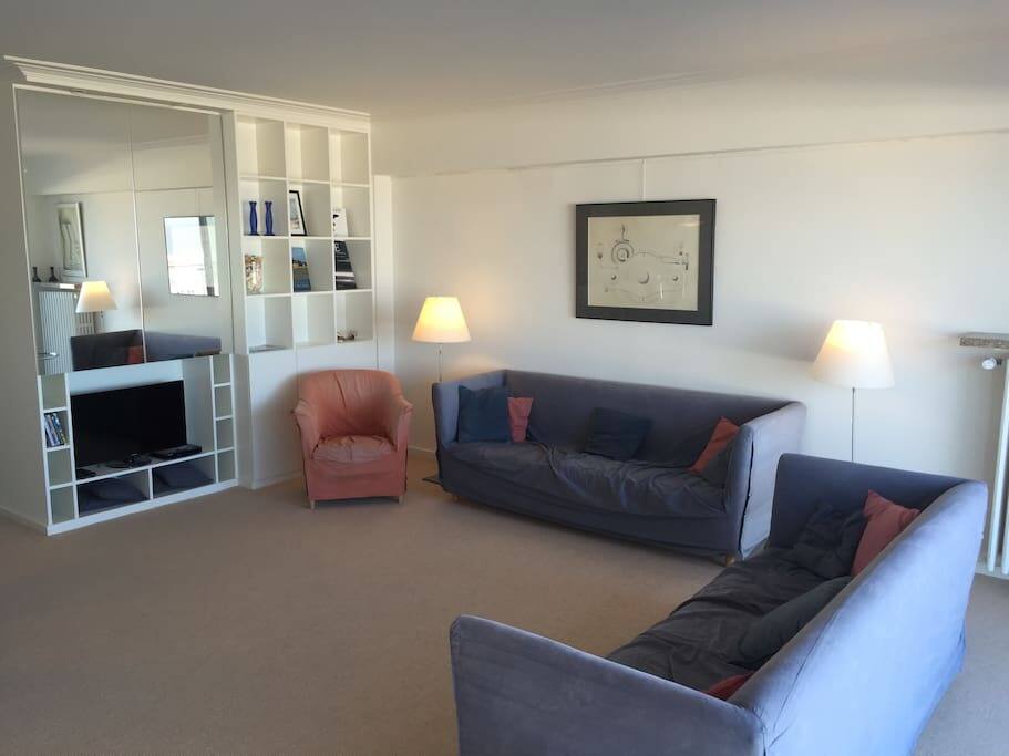 Living room with TV and reflection of the sea in the mirror