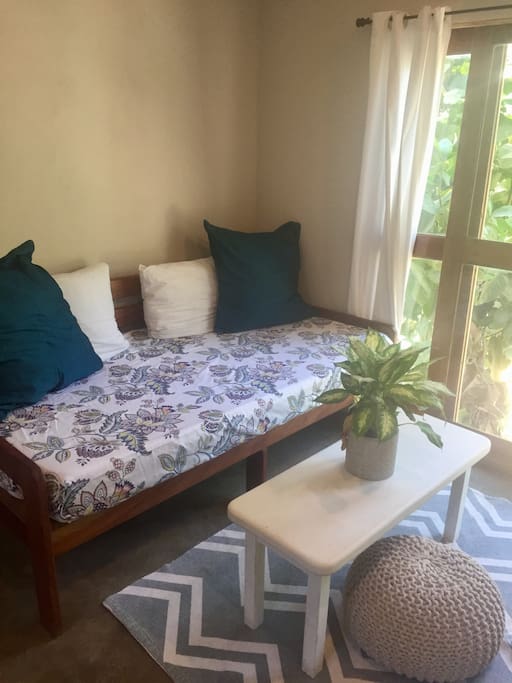 Living space with sofa day bed and view of the jungle