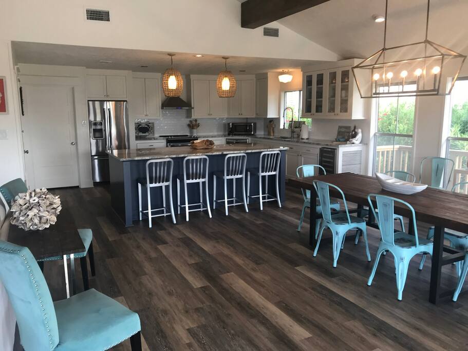 Dining area has a large granite counter with seating for 4, dining table for 8.