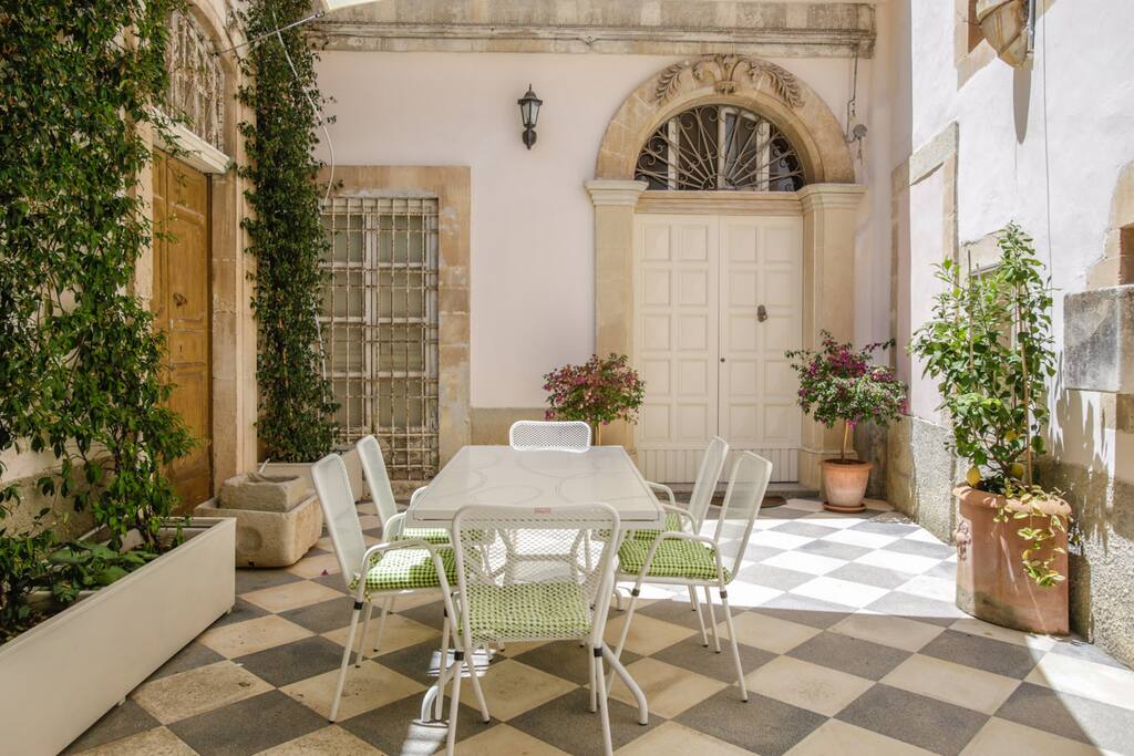 Entrance area: Outdoor dining table covered by a sun canopy.