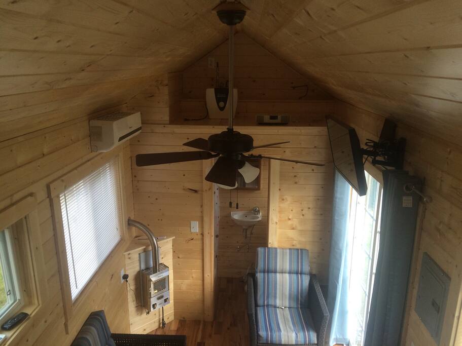 View from queen bed in loft. Note 2rd TV for local channels , air condition unit and marine fireplace for winter time.