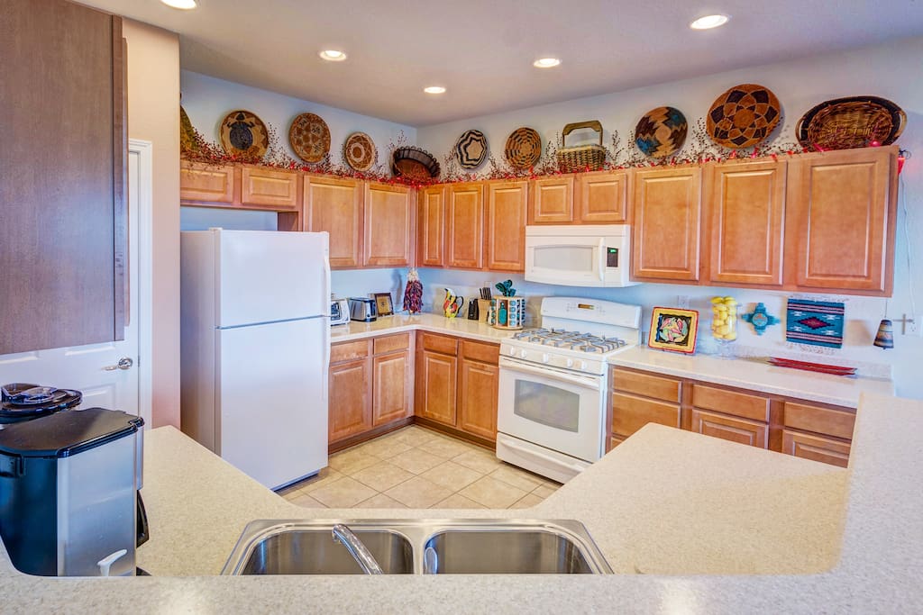 A modern kitchen with lots of everything you need. Coffee maker, blender, toaster, and so much more!