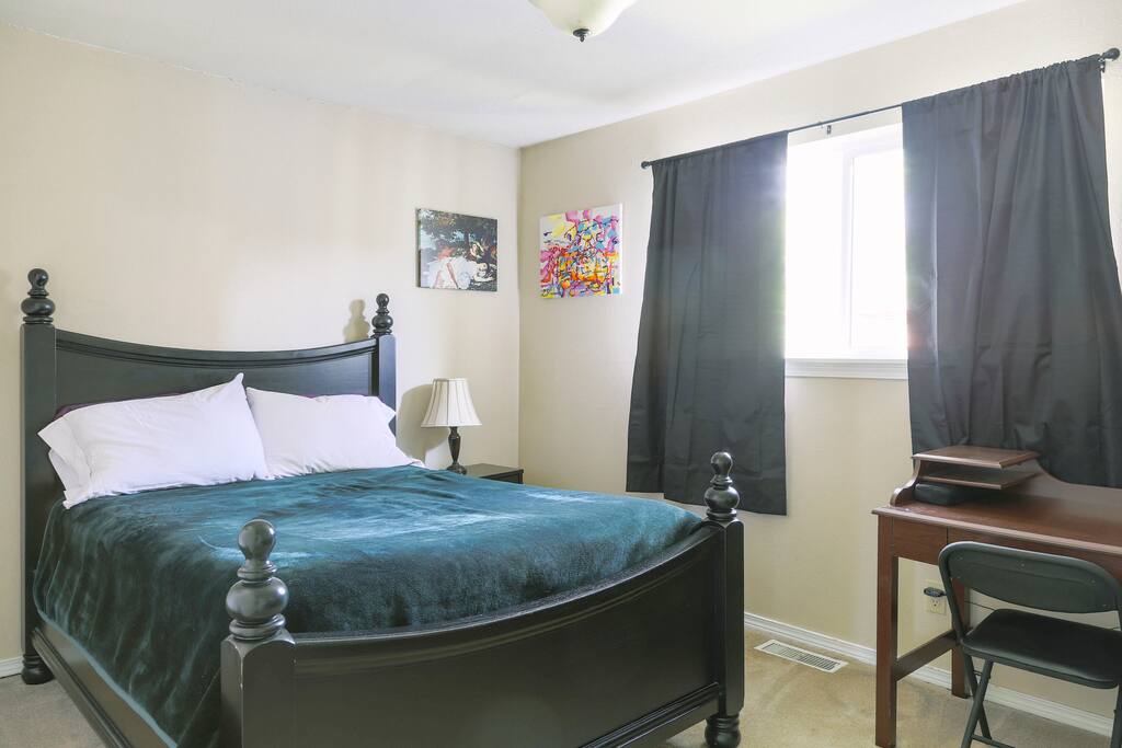 Well lit bedroom with desk