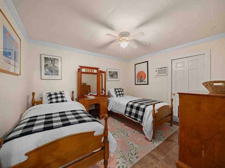 Lower level sleeping area - twin beds with fan, vanity and dresser. Has a door that closes for privacy and quiet from the rec room area.