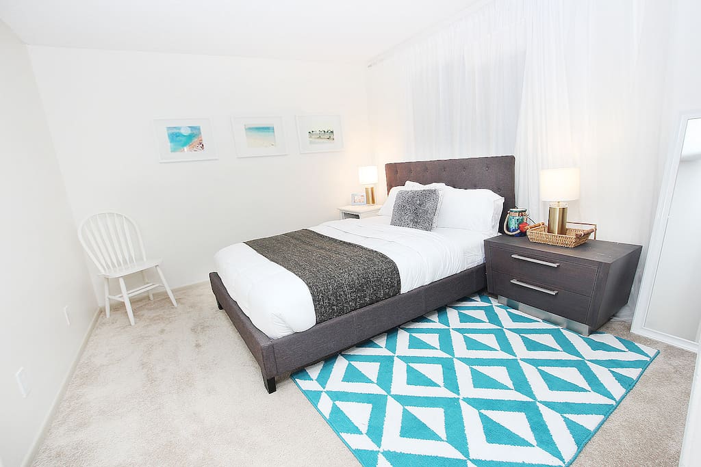Cozy queen bed with 2 twin beds for guests.