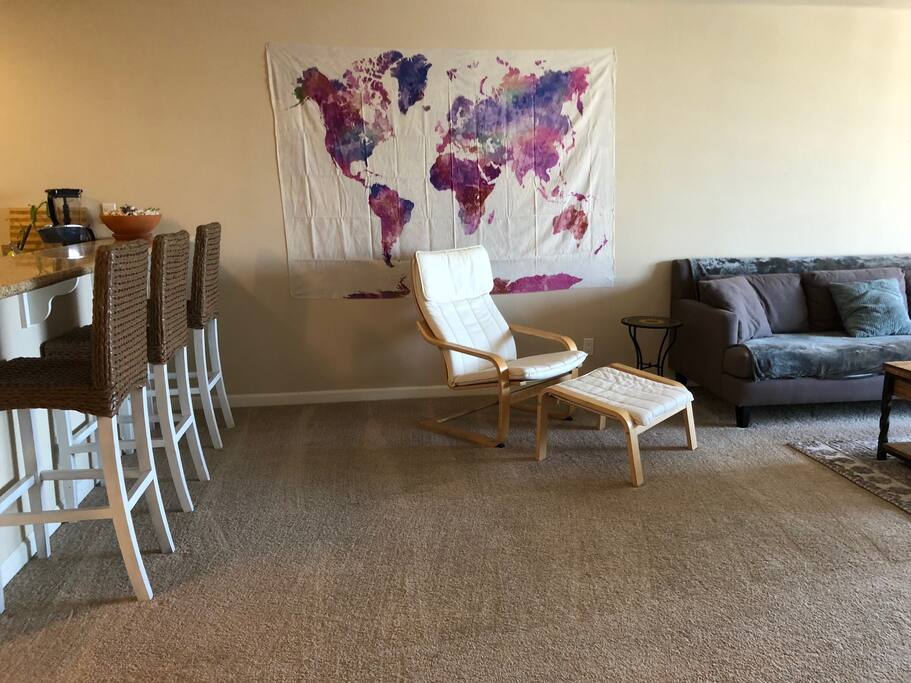 Living room, which opens up to the kitchen and kitchen bar seating area
