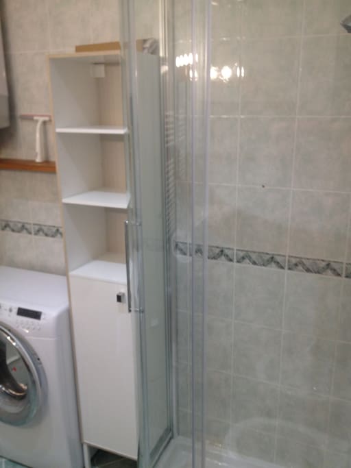 Bathroom with washer and shower